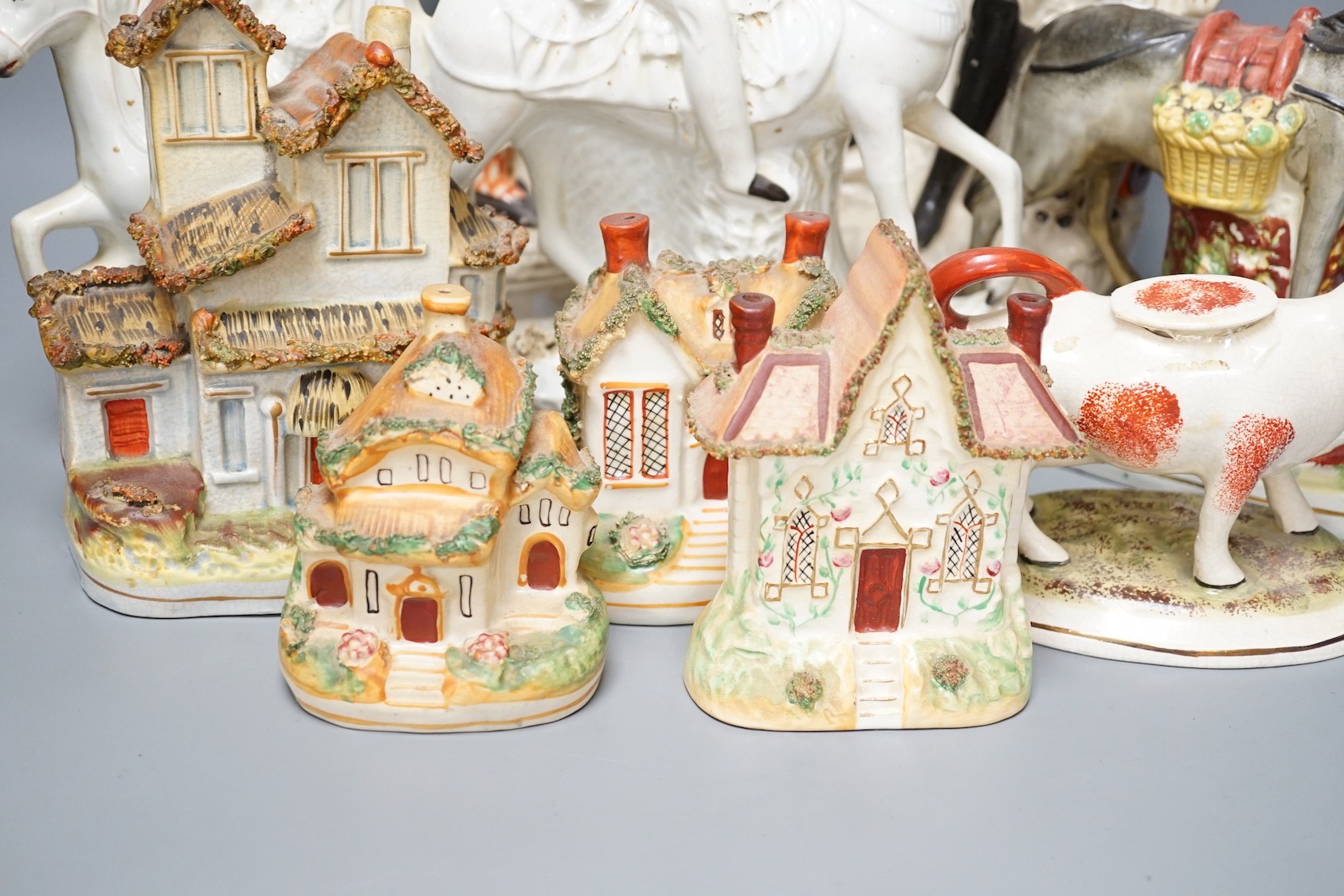 A group of Staffordshire including cottages and flatbacks